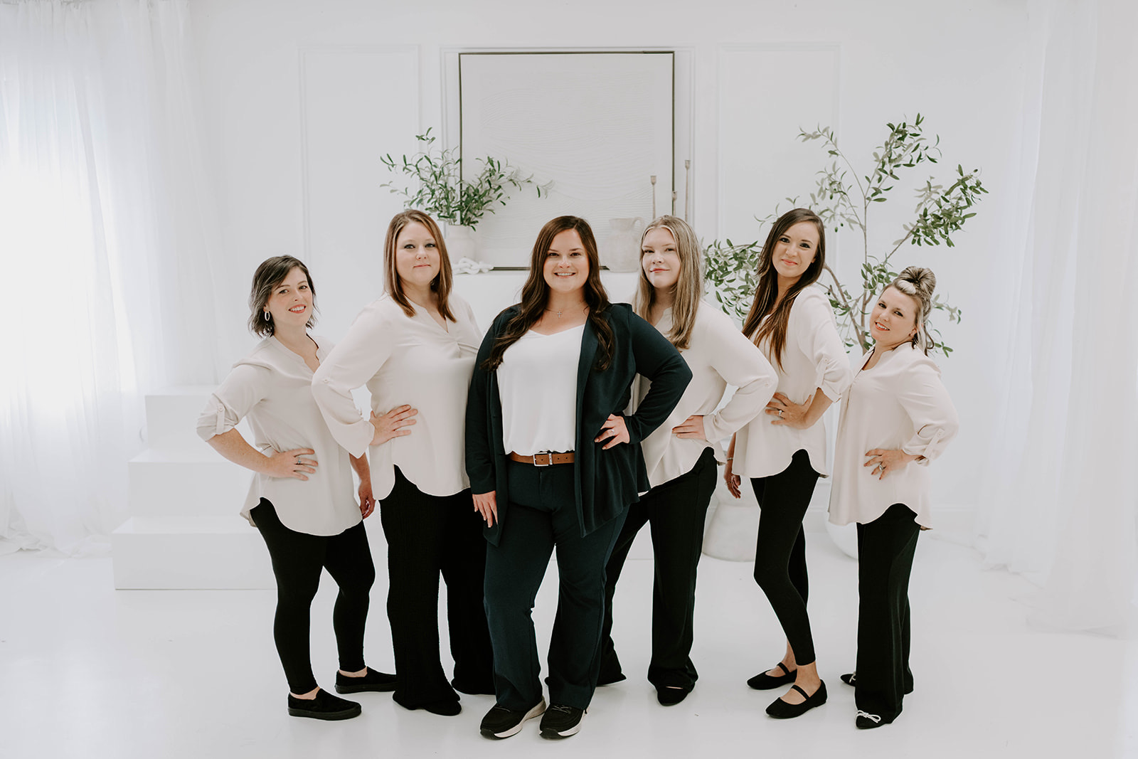 The cleaning team standing together in a bright studio