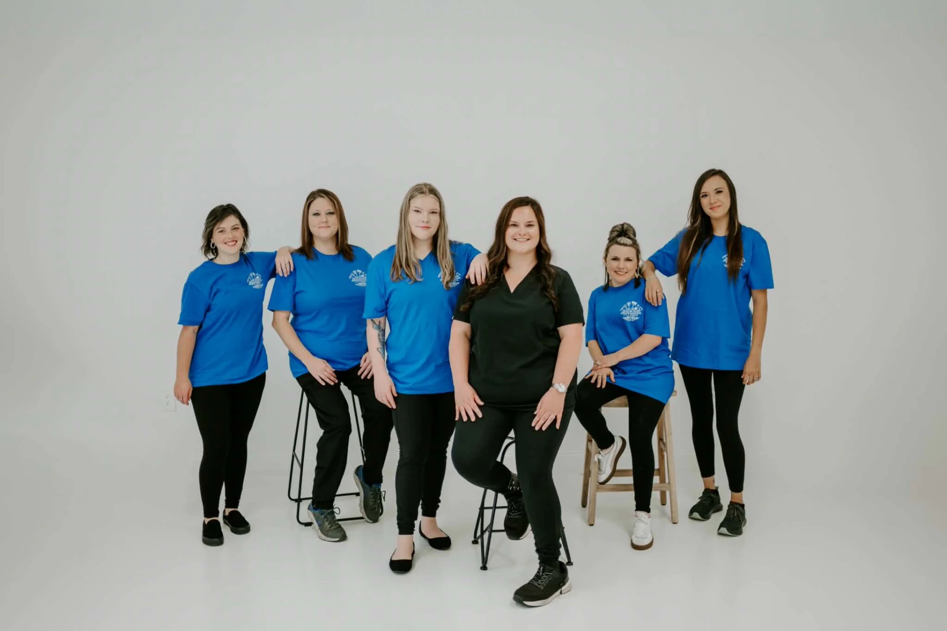 The Suzanna Hammond Cleaning team in bright blue work shirts